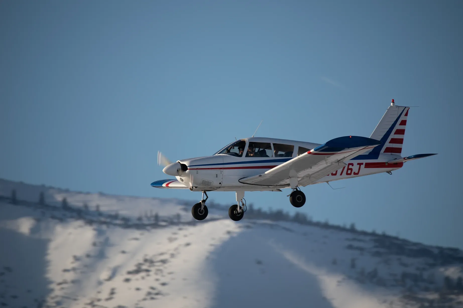 Training aircraft flying above the Sierra Nevada near Lake Tahoe